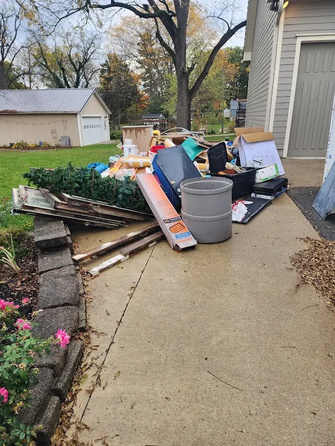 Dumpster being loaded with debris for Residential Dumpster Rental in Riley
